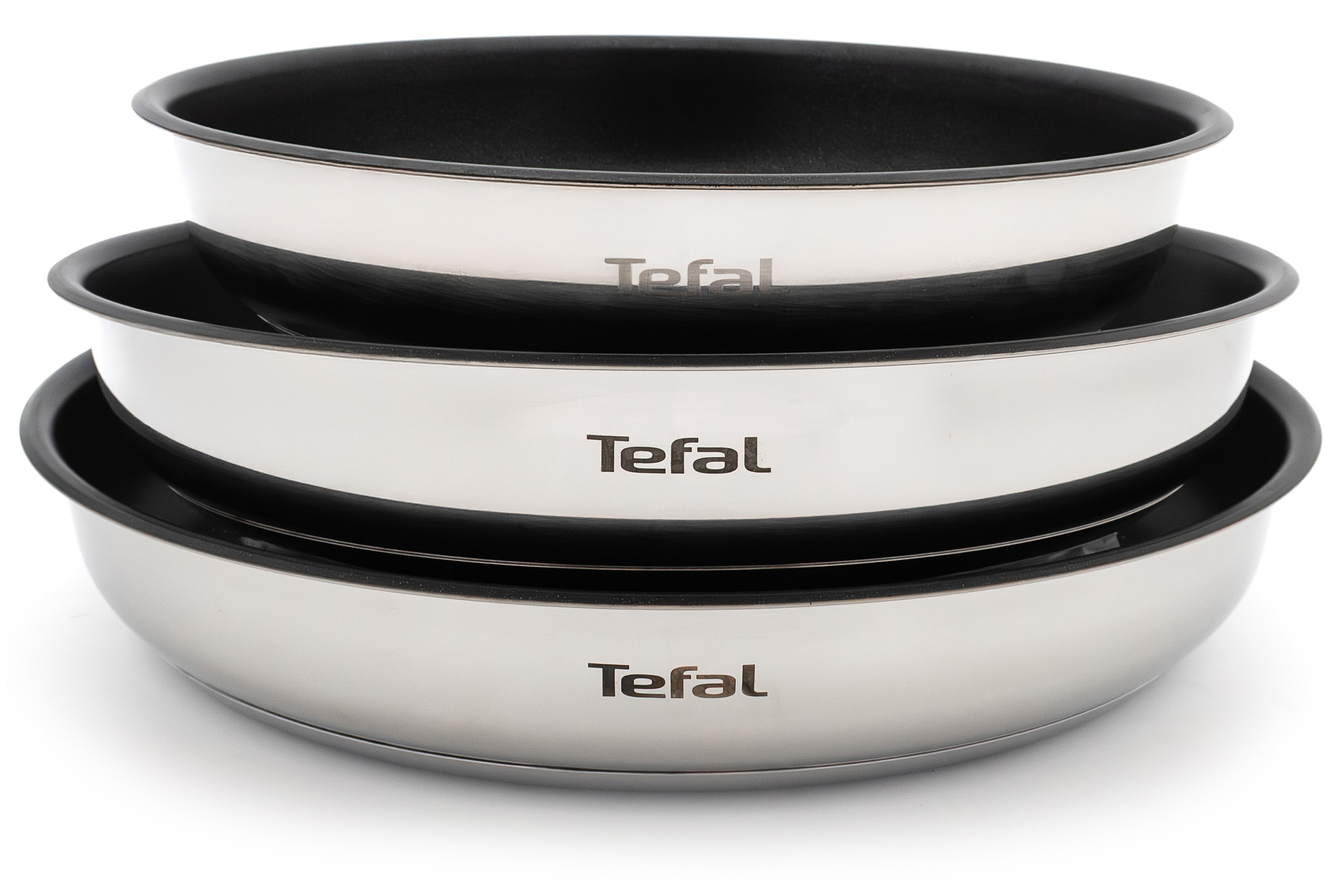 Trzy patelnie Tefal Ingenio Emotion z czarnymi powłokami, ułożone w stos, z widocznym logo Tefal.
